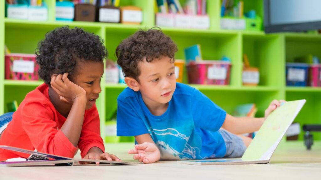 two young boys reading together